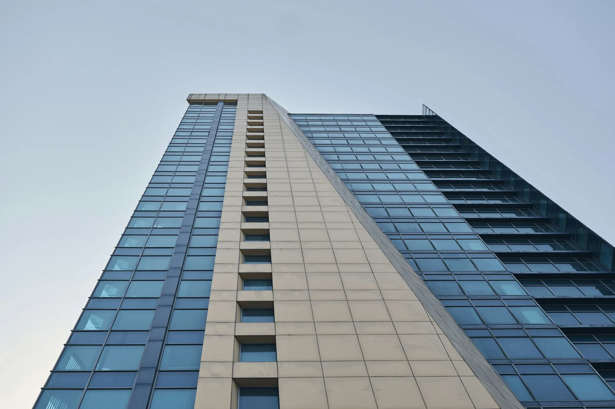 Tall office building with blue glass windows against the sky