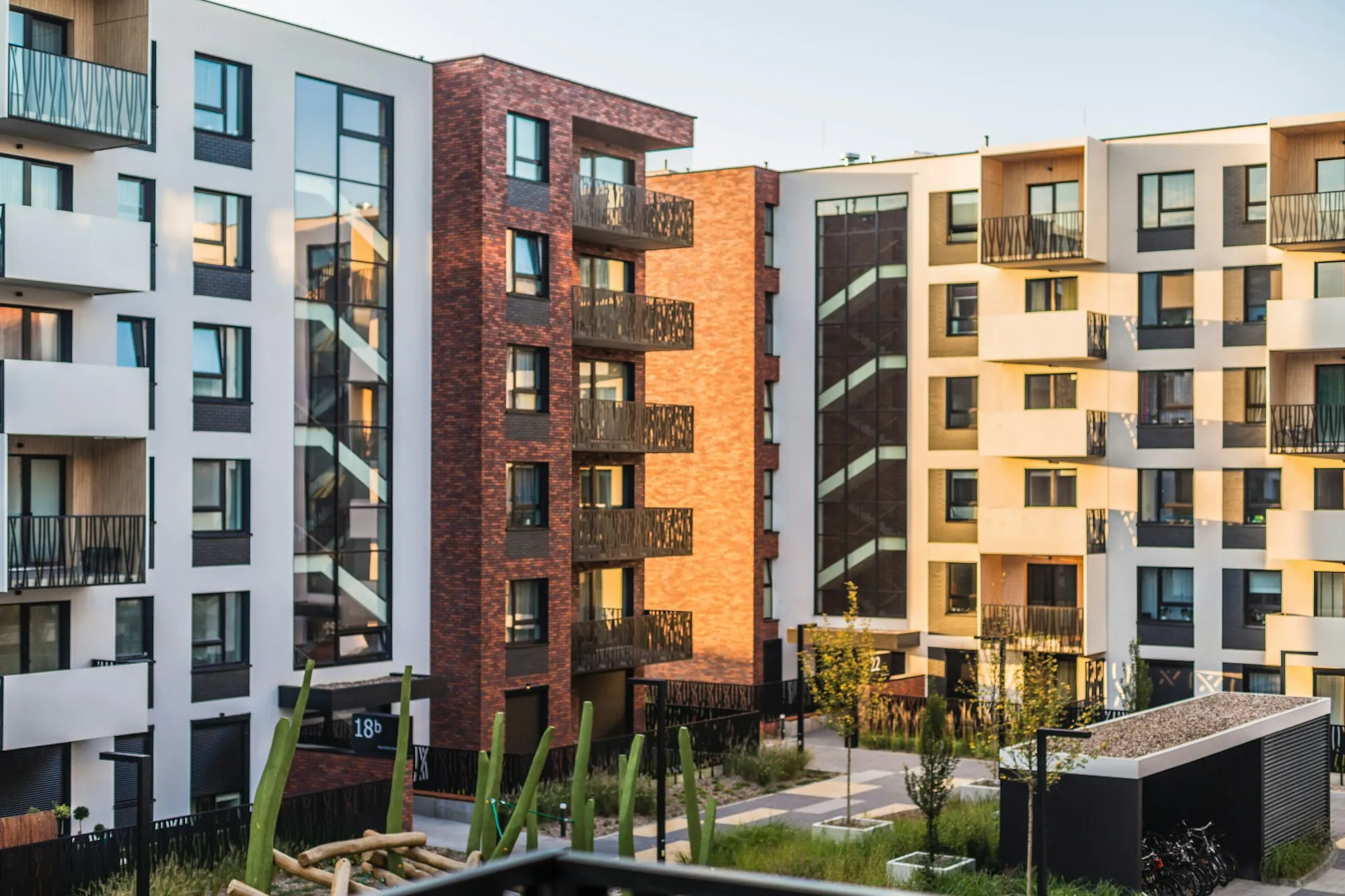 Modern apartment buildings around a landscaped courtyard